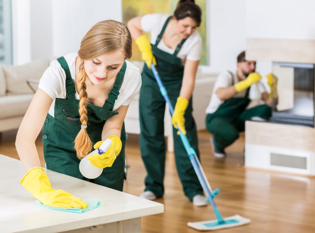 Nothing is better than team work Group of friends as a professional cleaners tiding up big apartment